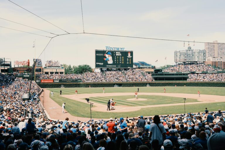 A lively baseball game at Wrigley Field with a packed stadium and urban skyline.