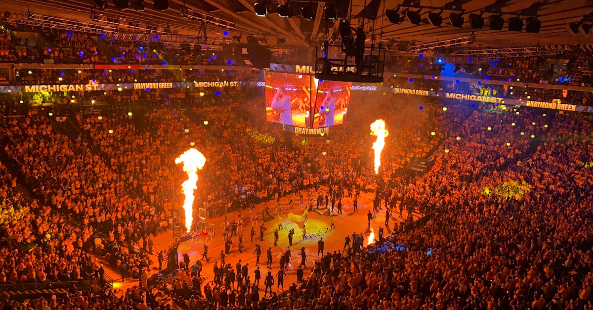 Lively basketball event with a huge crowd and fiery show in Oakland arena, capturing the vibrant sports atmosphere.